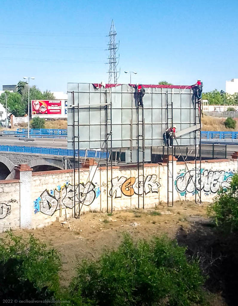 advertising walls under construction, I'll never know what's sold in Madrid